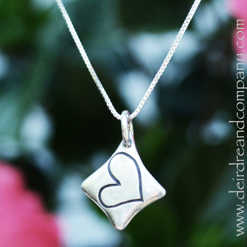 heart-inscribed-in-a-diamond-shaped-pendant-in-sterling-silver