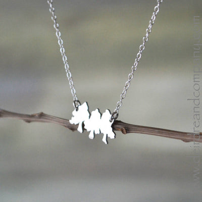 Three interconnected, tiny pine trees on adjustable cable chain in sterling silver. 
