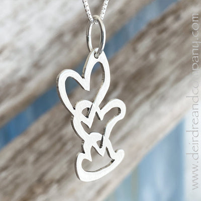 Three-hearts-intertwined-pendant-in-silver