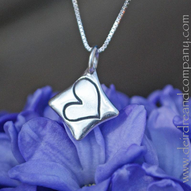 love-necklace-with-a-heart-inscribed-in-a-diamond-shaped-pendant-in-silver